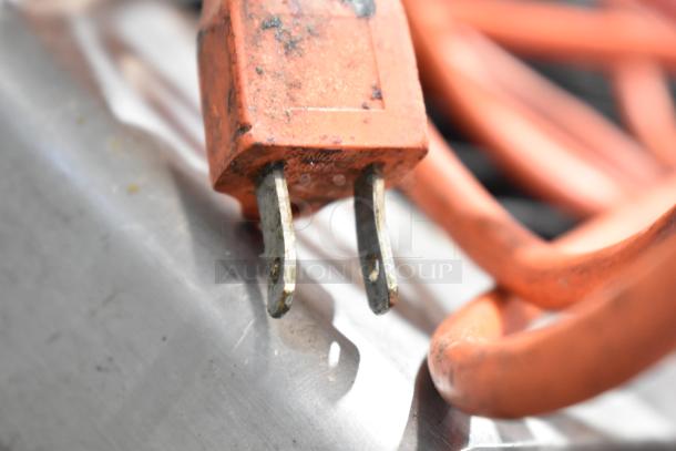 Red power cable of Globe Commercial Countertop Automatic Meat Slicer, highlighting standard plug and wear marks. 115 Volts, 1 Phase.