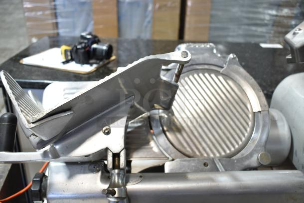 Globe Commercial Countertop Automatic Meat Slicer with Blade Sharpener, 115 Volts, 1 Phase, stainless steel body.