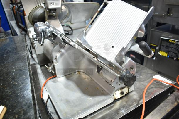 Globe commercial countertop automatic meat slicer with blade sharpener, runs on 115 volts, 1 phase, in used condition.