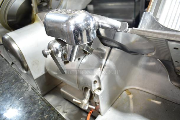 Globe countertop automatic meat slicer, stainless steel, with blade sharpener. 115 volts, 1 phase. Visible wear.