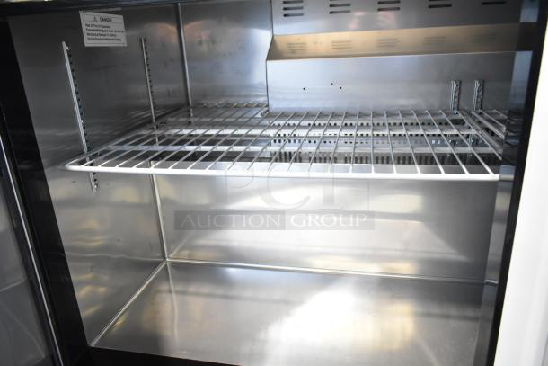 Avantco 178AU60R commercial 2 door undercounter cooler with shelves, stainless interior, on casters, 115V, 1 phase.