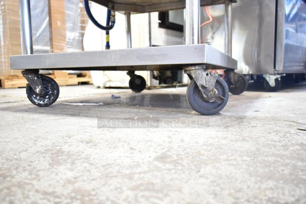 Vulcan countertop gas charbroiler grill with equipment stand and commercial casters, suitable for heavy-duty use.