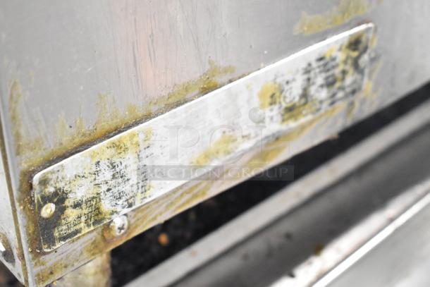 Vulcan Commercial Gas Charbroiler Grill, stainless steel, visible wear and grime, equipment label partially obscured.