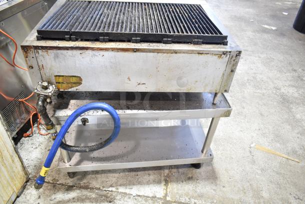 Vulcan commercial countertop gas charbroiler grill with stains, on steel stand with commercial casters, visible wear.