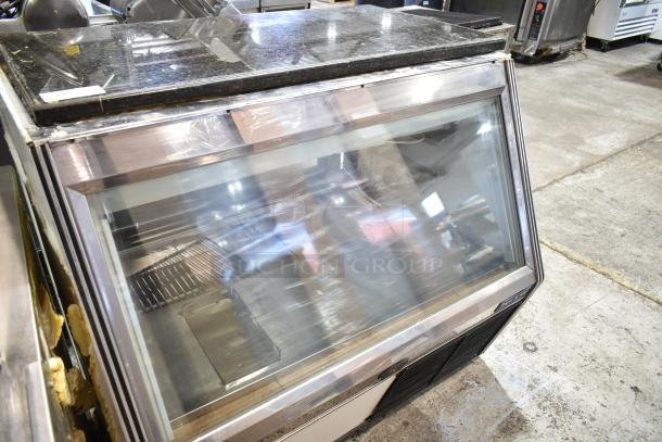 Marc commercial deli display case, glass front, metal frame, black granite top. 115 volts, 1 phase, good condition.