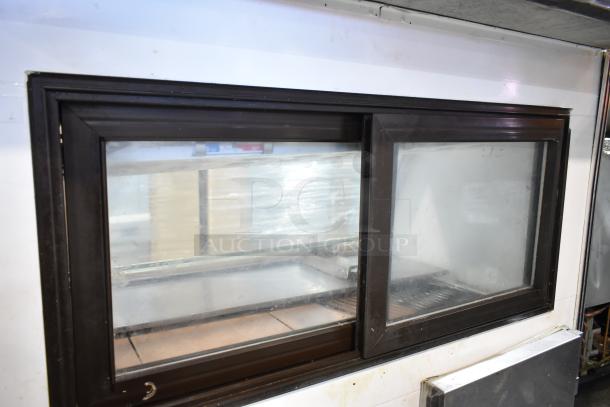 Marc commercial deli display case, glass front, black and white frame, 115V, 1 phase. Used condition.