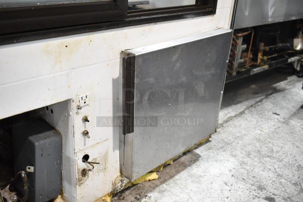 Marc Commercial Floor Deli Display Case Merchandiser, 115V, 1 Phase. Visible wear and electrical outlet on side.