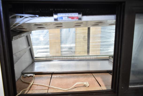 Marc commercial deli display case, 115 volts, 1 phase. Features glass front and shelving. Used condition.