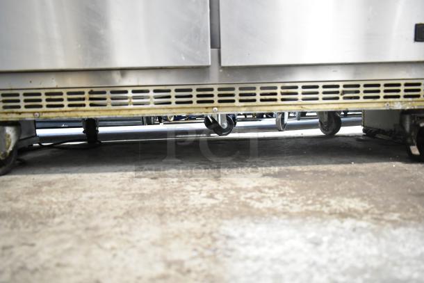 Everest EPBR2 commercial prep table, missing back part of top, on casters. 115V, 1 phase. Visible wear on casters and surface.