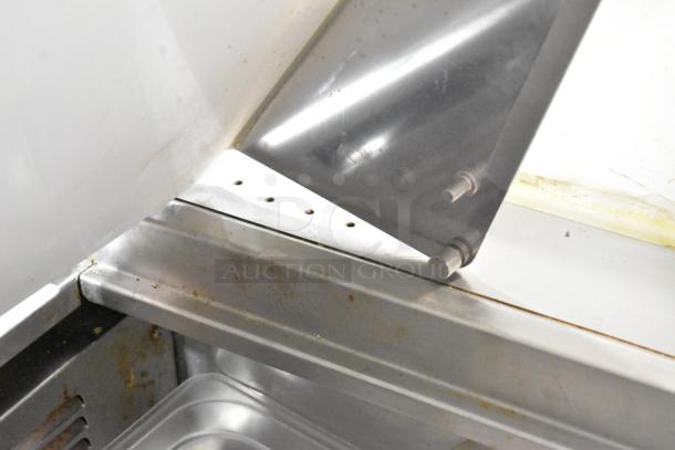 Everest EPBR2 sandwich salad prep table; missing back part of mega top; stainless steel; commercial casters visible.