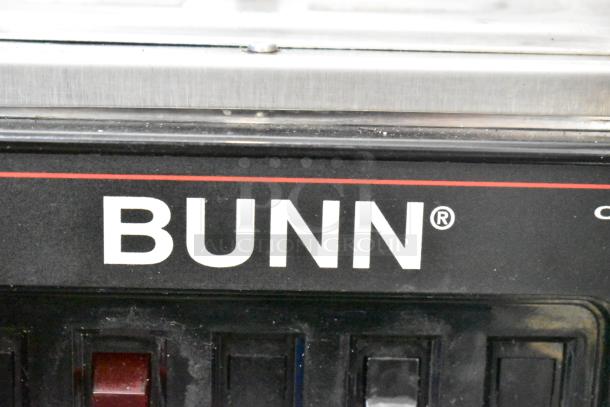 Bunn commercial countertop coffee machine with hot water dispenser, featuring a stainless steel exterior and control panel.