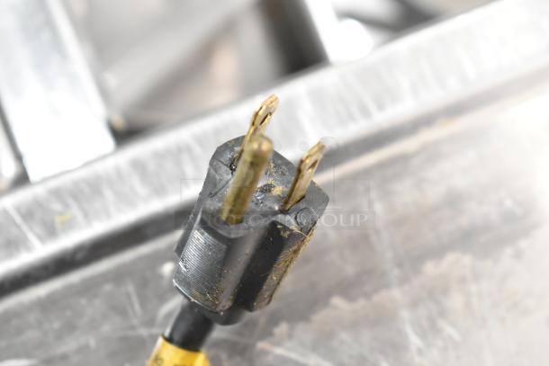 A worn electrical plug of a Bunn Commercial Countertop Coffee Machine with a hot water dispenser.