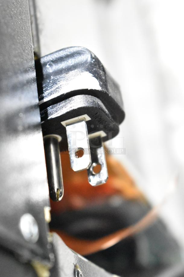 Close-up of a QBD CD26-HC cooler power plug, 115 volts, 1 phase, showcasing the prongs and plug condition.