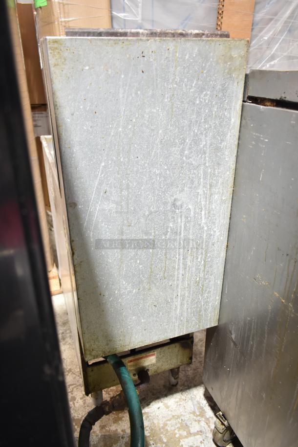 Pitco Frialator commercial gas floor fryer, used condition, visible wear and rust, green hose attached.