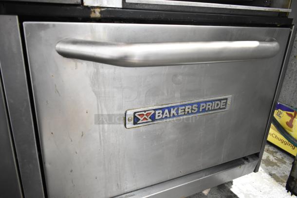 Bakers Pride gas-powered range with 6 burners, flat top griddle, cheese melter, 2 ovens, and backsplash. Visible logo.