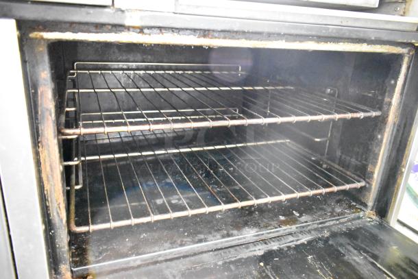 Bakers Pride commercial oven interior showing two wire racks, used condition, with visible wear and discoloration.