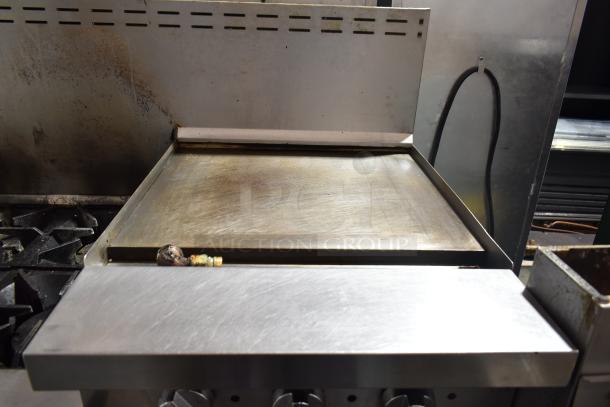 Bakers Pride 6-burner gas range with flat top griddle, cheese melter, 2 ovens, and backsplash; used condition.