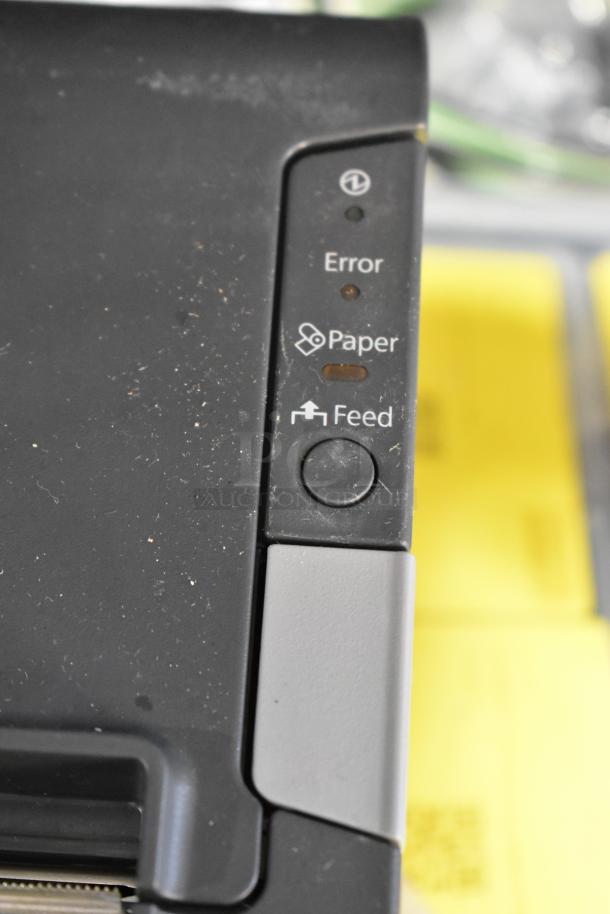 Epson receipt printer close-up showing control panel with error, paper, and feed buttons. Model M244A is included.