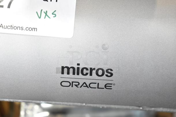 5 Micros Oracle POS docking stations, silver, with branding visible. Auction label indicates "5 times your bid."