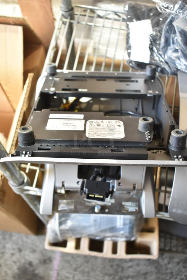 5 Micros Oracle POS docking stations, showing moderate wear. Includes power connectors. Labels show compliance markings.