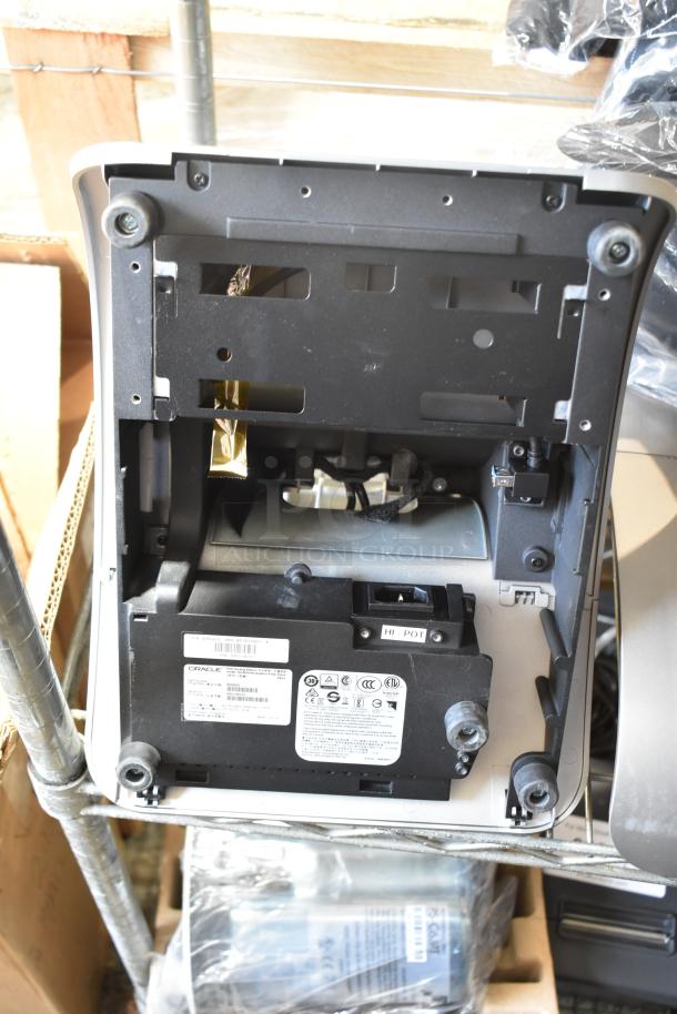 5 Micros Oracle POS docking stations, gently used. Shows Oracle branding and certification labels. Ideal for POS systems.