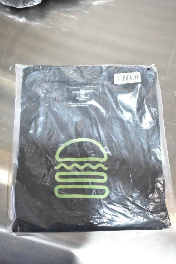 Brand new Shake Shack unisex Steff tee in package, size 2XL. Black with green burger logo. 100% cotton.