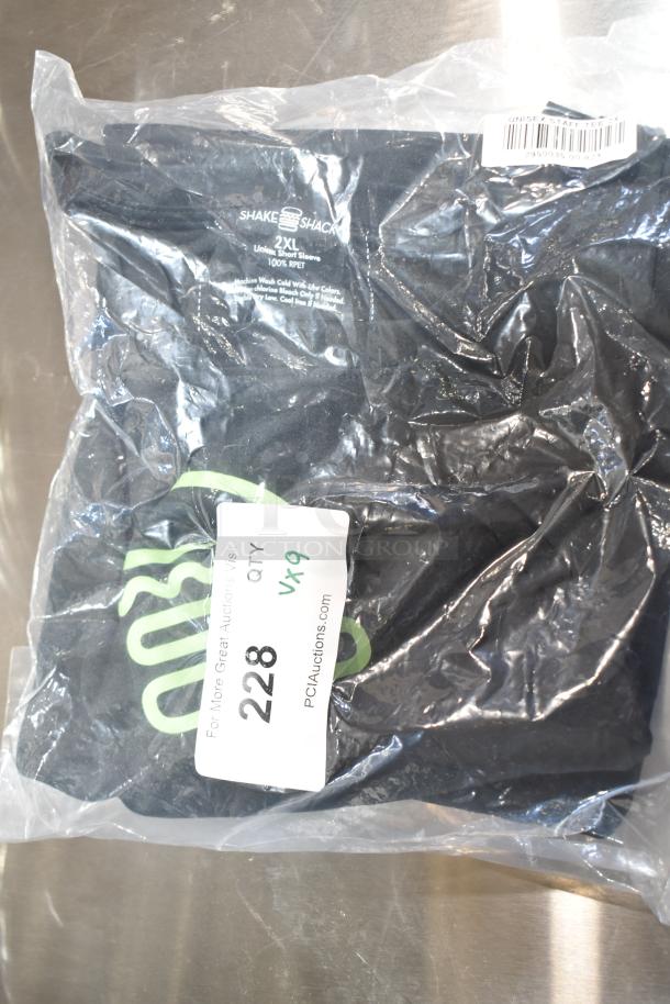 9 new scratch and dent items, including unisex Steff Tees in 2XL. Tags indicate brand and washing instructions.