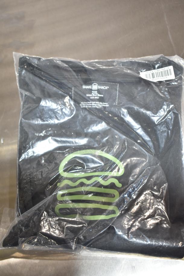 Brand new Shake Shack unisex 2XL tee, packaged. Features logo, 100% cotton, short sleeve. Auction includes 9 items.