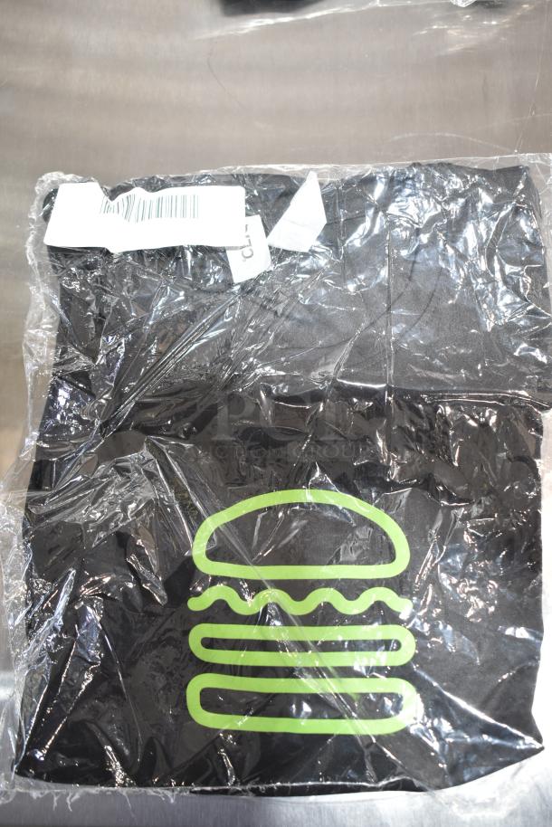 Nine brand new scratch and dent tees, including unisex Steff tees. Includes 2X size. Packaged with visible tags and green logo design.