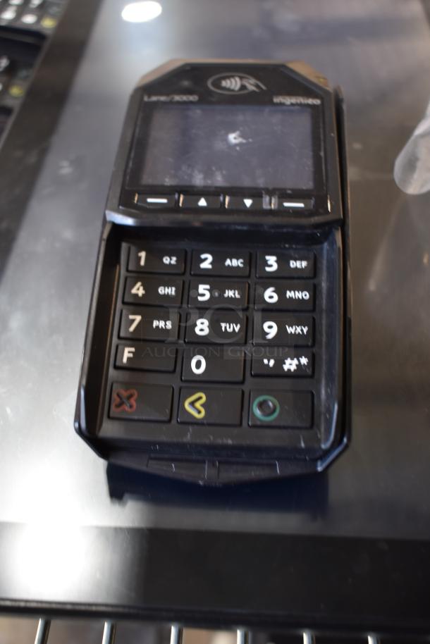 Ingenico Lane/3000 credit card reader, slightly used condition, visible keypad, touchless payment symbol on top.