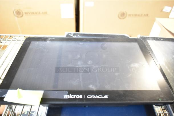 Micros Oracle POS monitor with visible smudges, part of a lot including monitors and Ingenico credit card readers.