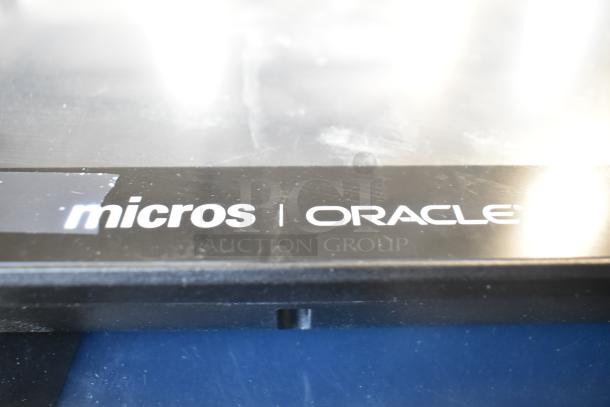 Micros Oracle POS monitor close-up, displaying brand logo on screen edge. Part of 10-item auction lot.