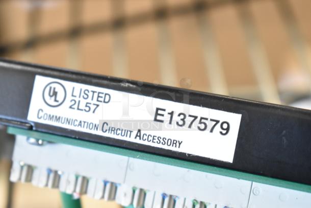 Close-up of UL Listed communication circuit accessory, model E137579.