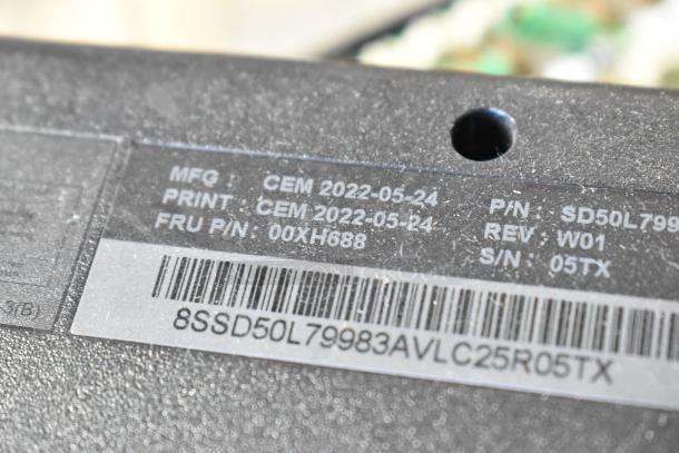 Label on electronic equipment showing manufacturing and part details, dates, and serial numbers. Includes barcodes.