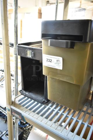 Two plastic bins on a metal shelf, one black, one olive green with a "232 QTY x 2" label, indicating auction lot.