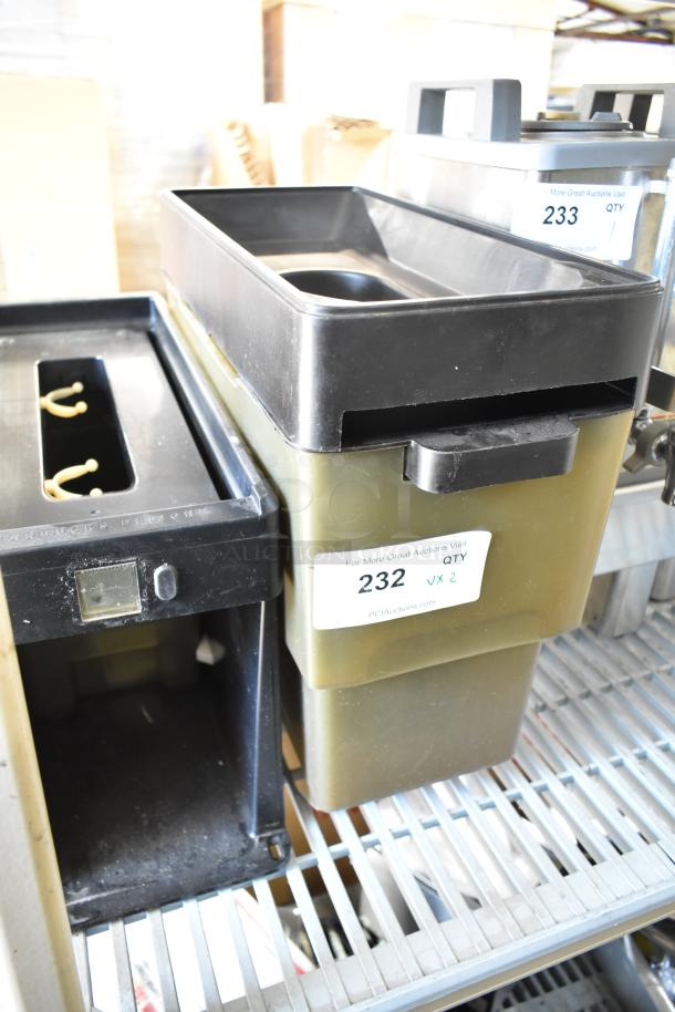2 plastic bins with black lids on a shelf, labeled "232 QTY 2." Used condition, ideal for storage or organization.