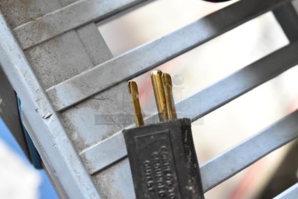 Close-up of a power plug with visible prongs. No specific details about the Bunn SH-S Server visible.