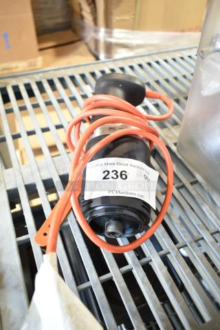 Immersion blender without blade, 115 volts, 1 phase. Wrapped orange cord, NSF marking, auction tag 236 visible.