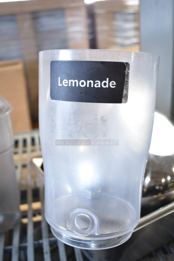Clear poly bin with "Lemonade" label, part of a lot with various items. Used condition, suitable for storage or display.