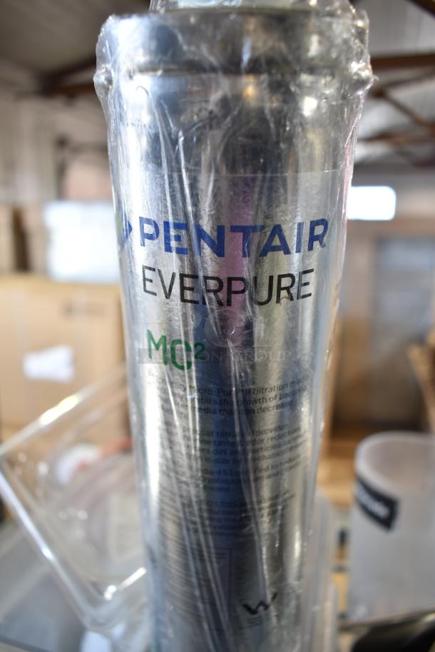 Lot including Pentair Everpure MC2 filter wrapped in plastic, with bowl, drop-in bins, and poly bin. Used condition.