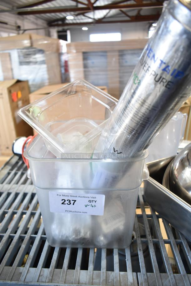 Lot of various items including a clear poly bin with label "237," a metal bowl, drop-in bins, and a cylindrical container.