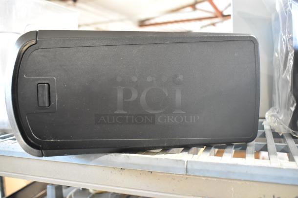 Two countertop napkin dispensers, black, rectangular, good condition, suitable for commercial use.