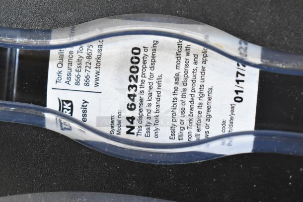 Two Tork countertop napkin dispensers, model N4 6432000, shown with branding and use instructions label.