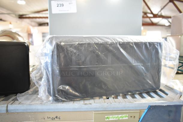 Two countertop napkin dispensers, wrapped in plastic, on display. Item tag shows "Lot 239."