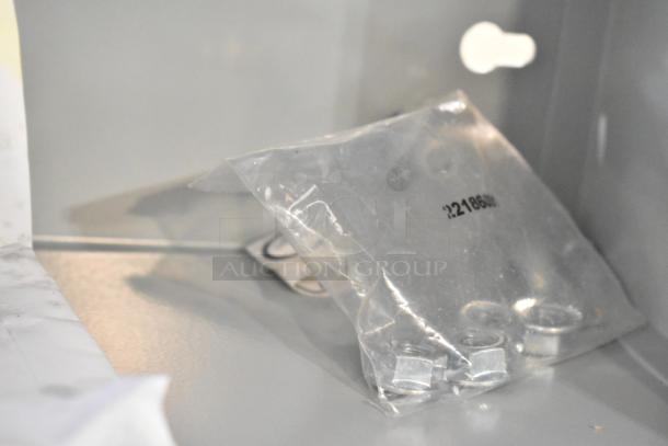 Dayton A16N16ALP gray enclosure, new condition, includes spare parts in a labeled bag. Ideal for electrical applications.