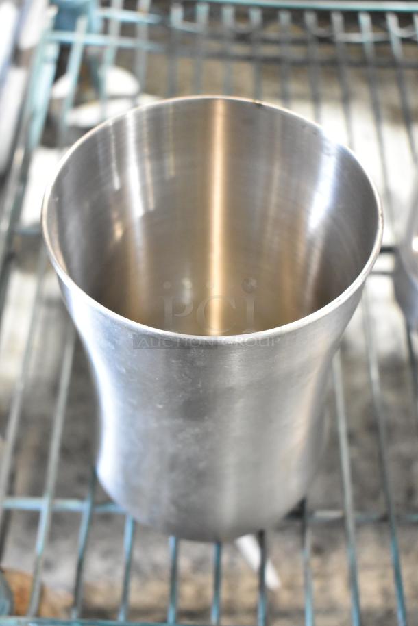 Stainless steel metal cup, cylindrical with a smooth finish, part of a mixed item auction tier lot.