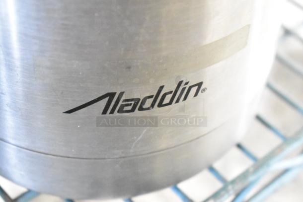 Aladdin branded metal item, part of a tier lot including blender pitcher and metal bowls. Appears in used condition.