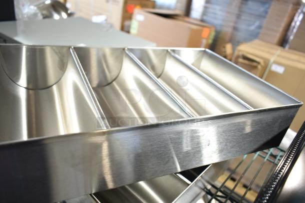 Stainless steel silverware caddy with four compartments in excellent condition, ideal for organizing utensils.