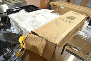 Various items including black poly trays and poly insulated bins, with a Cambro RFS4148 4qt container in an open box. Items in good condition.