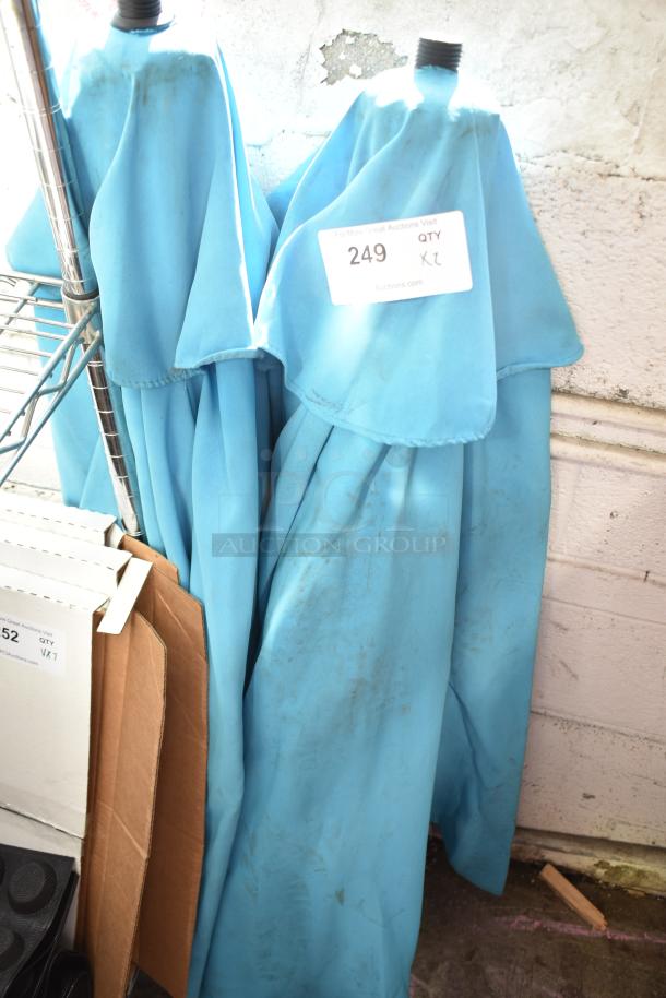 Two blue patio umbrellas with visible dirt marks, size XL tag, item number 249.